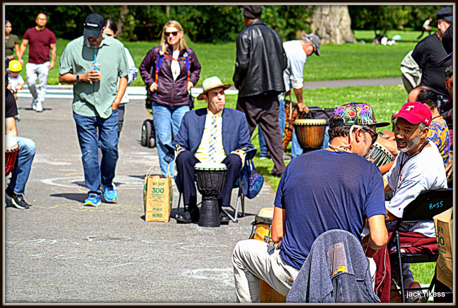 Drum Circle — man in suit playing djembe