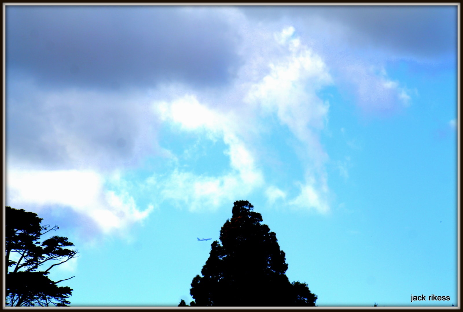 My Neighborhood — rocky peak silhouetted against bright blue sky