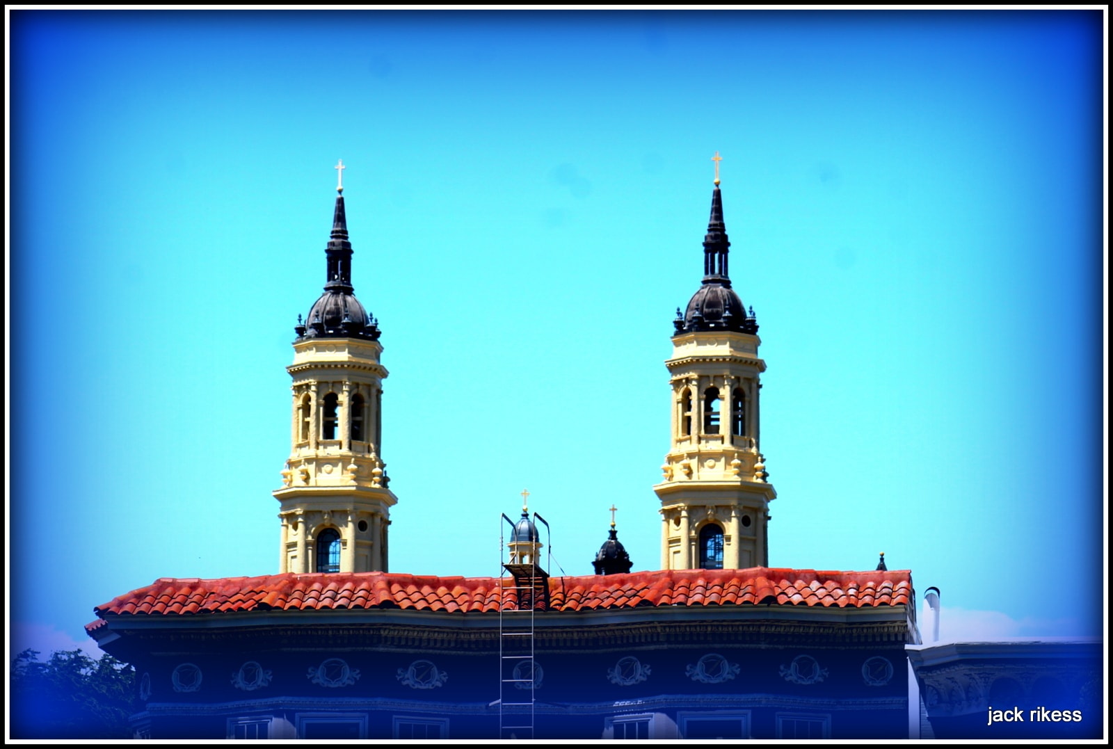 My Neighborhood — twin church towers against bright blue sky