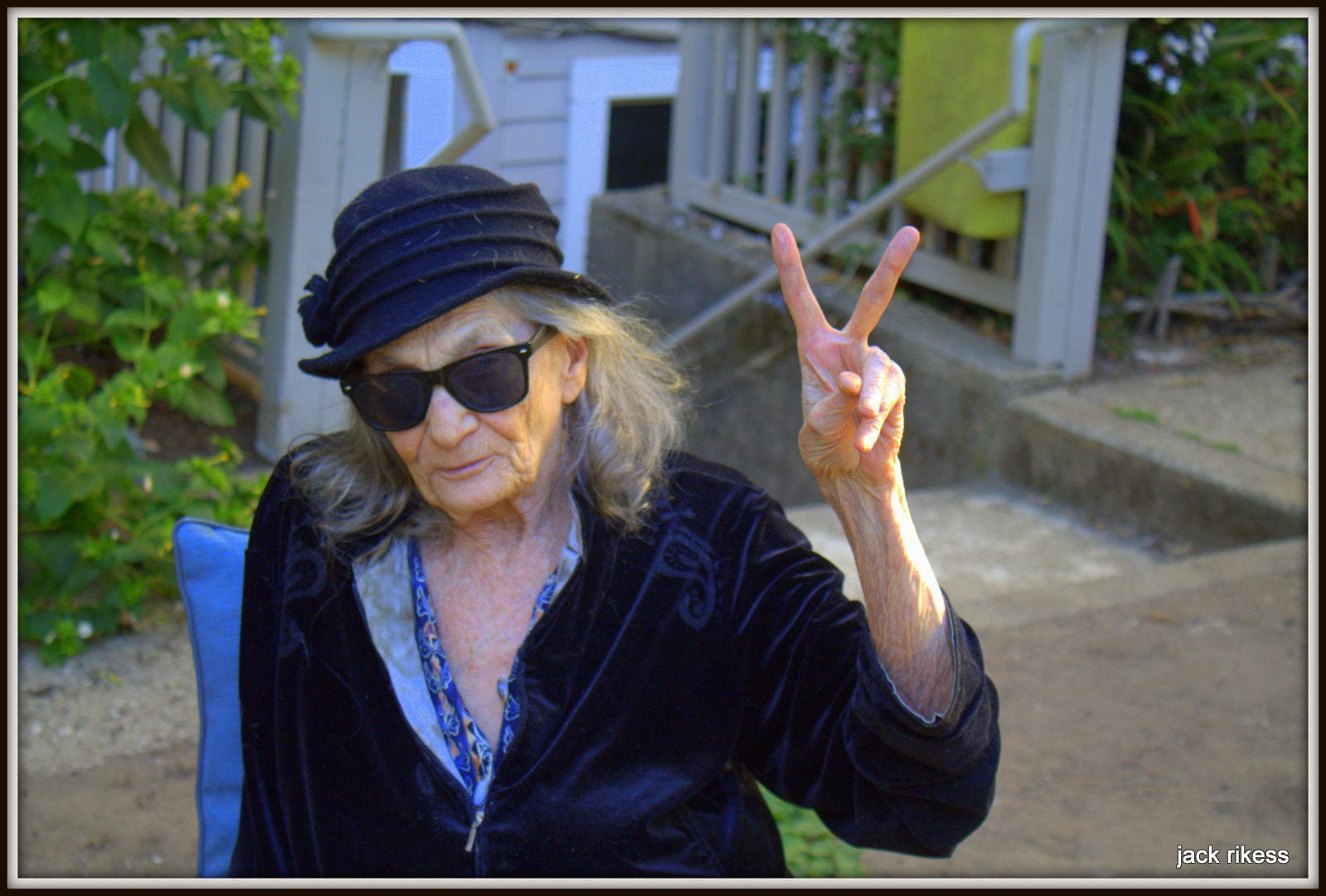 Pebbles — giving peace sign in sunglasses outdoors
