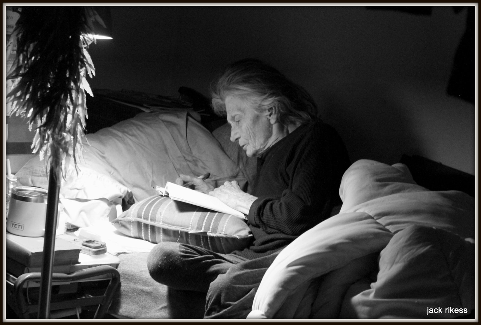 Pebbles — reading by lamplight, black and white
