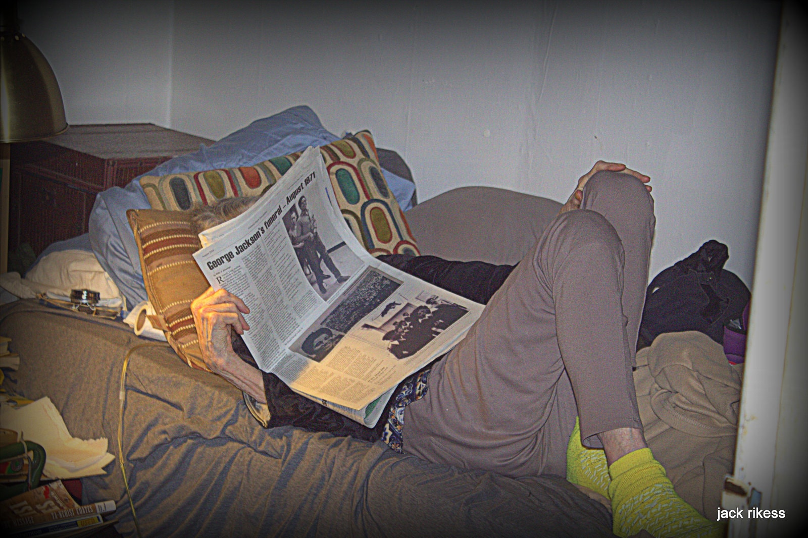 Pebbles — reading newspaper on bed