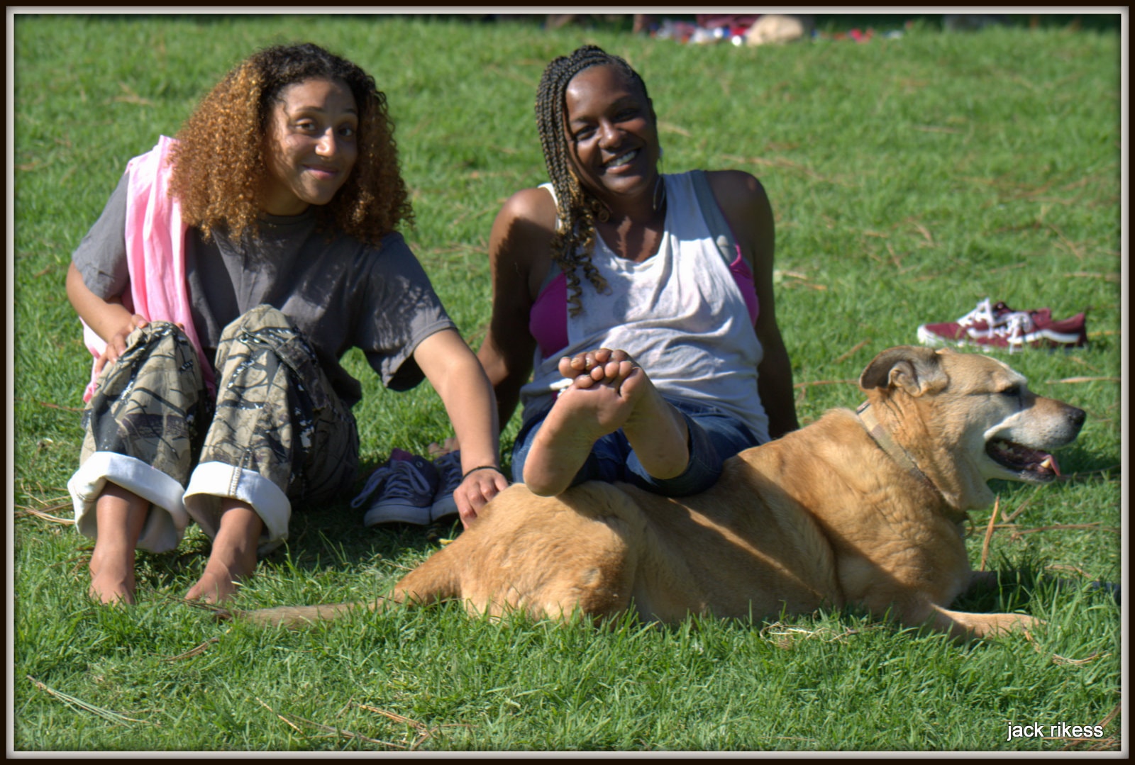 Stella and Friends — two women sitting on the grass with Stella